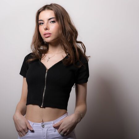 Young beautiful stylish girl posing in studio.の写真素材