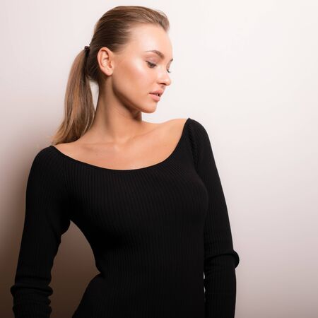 Young beautiful stylish girl posing in studio.の写真素材