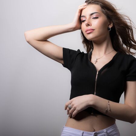 Young beautiful stylish girl posing in studio.