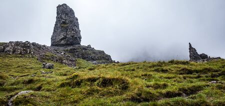Old Man of Storr on the Isle of Skye in Scotland. Mountain landscape with foggy clouds.の写真素材