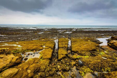 Waves breaking on coastal cliffs of Scotland.の写真素材