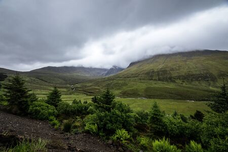 Beautiful scenic landscape of amazing Scotland nature and mountain trail road.の写真素材
