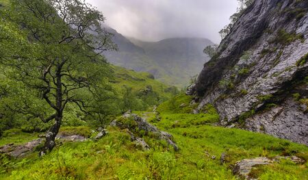 Beautiful mountains landscape of Scotland nature with beautiful evening cloudy skyの写真素材
