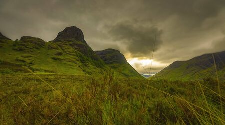 Beautiful scenic landscape of Scotland nature with beautiful evening sun set skyの写真素材