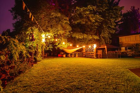 Multi-colored night lighting of the Scottish house gardenの写真素材