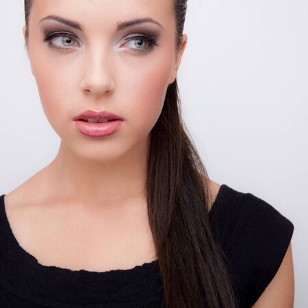 Young beautiful stylish girl posing in studio.の写真素材
