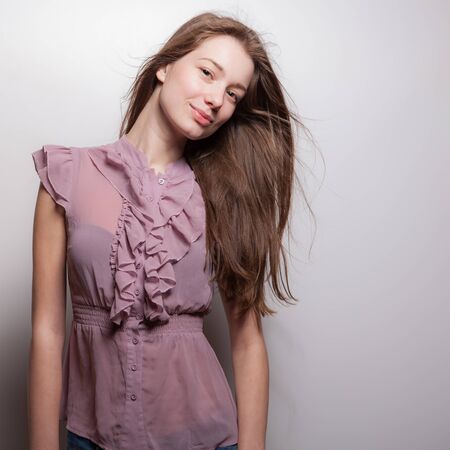 Young beautiful stylish girl posing in studio.の写真素材
