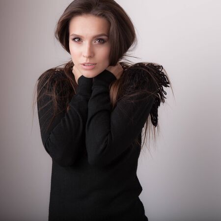 Young beautiful stylish girl posing in studio.の写真素材