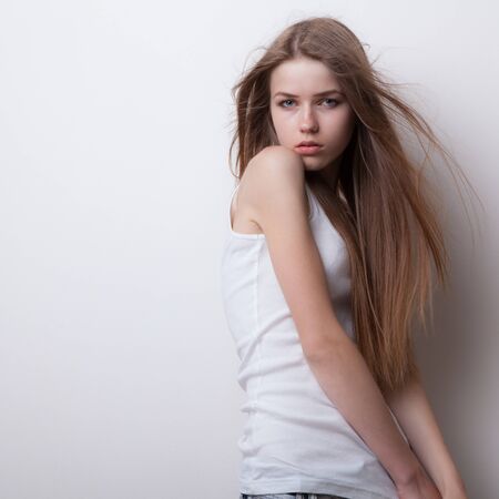 Young beautiful stylish girl posing in studio.の写真素材