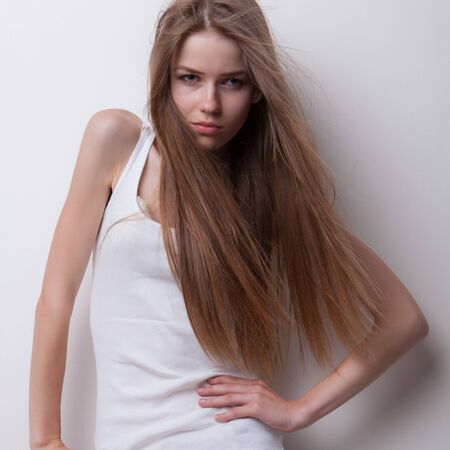 Young beautiful stylish girl posing in studio.の写真素材