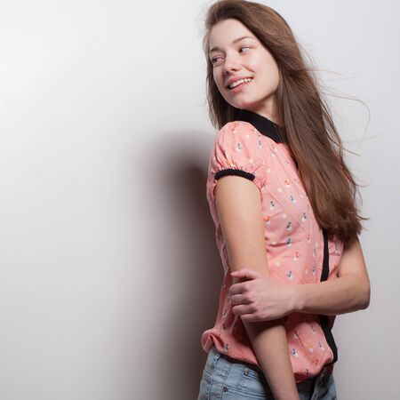 Young beautiful stylish girl posing in studio.の写真素材