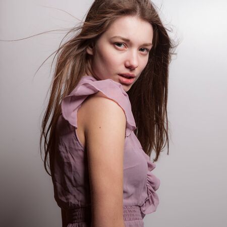 Young beautiful stylish girl posing in studio.の写真素材