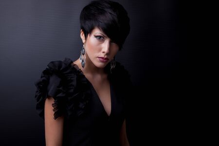 Young beautiful stylish girl posing in studio.の写真素材
