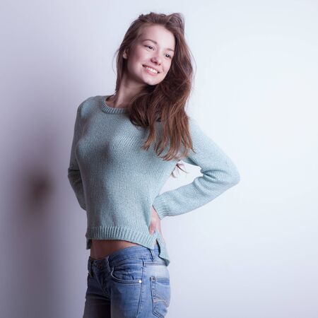 Young beautiful stylish girl posing in studio.の写真素材