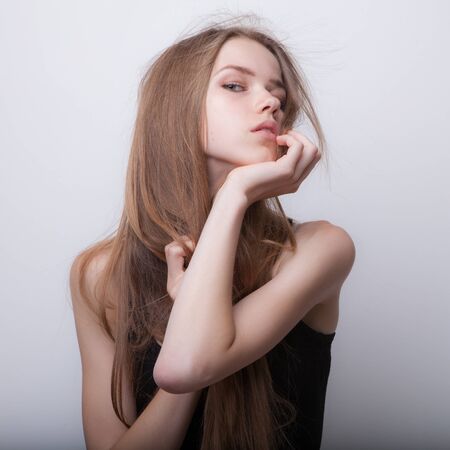 Young beautiful stylish girl posing in studio.の写真素材