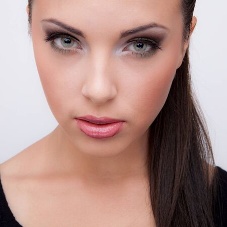 Young beautiful stylish girl posing in studio.の写真素材