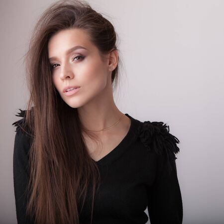 Young beautiful stylish girl posing in studio.の写真素材