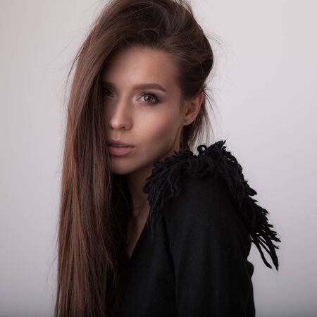 Young beautiful stylish girl posing in studio.の写真素材