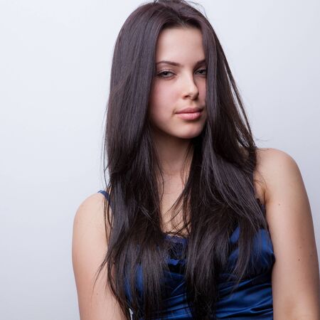 Young beautiful stylish girl posing in studio.の写真素材