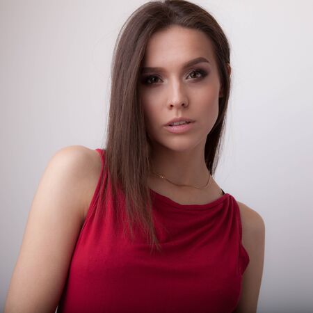Young beautiful stylish girl posing in studio.の写真素材