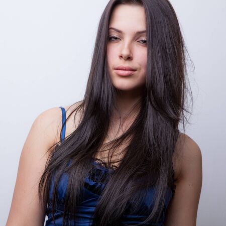 Young beautiful stylish girl posing in studio.の写真素材