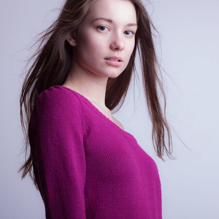 Young beautiful stylish girl posing in studio.の写真素材