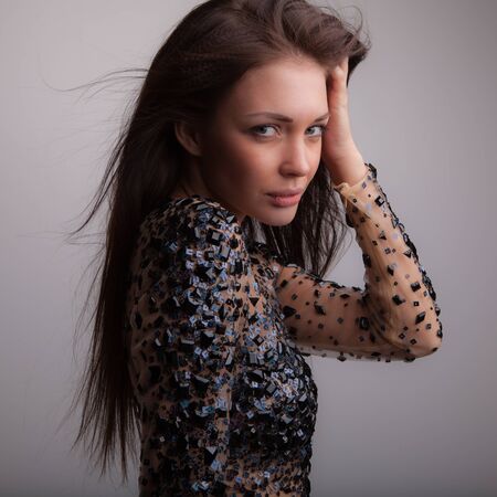 Young beautiful stylish girl posing in studio.の写真素材