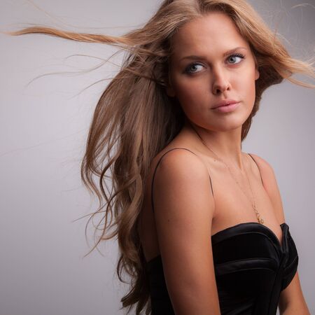 Young beautiful stylish girl posing in studio.の写真素材