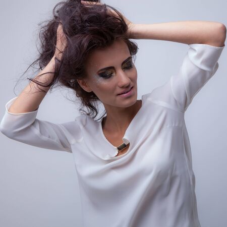 Young beautiful stylish girl posing in studio.の写真素材