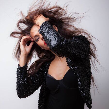 Young beautiful stylish girl posing in studio.の写真素材