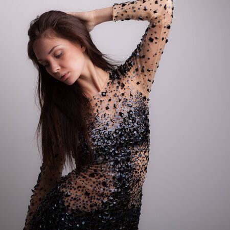 Young beautiful stylish girl posing in studio.の写真素材