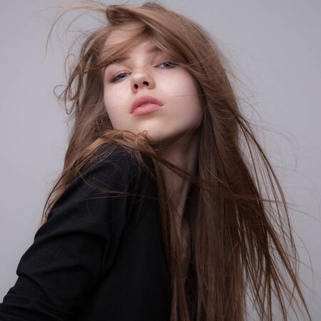 Young beautiful stylish girl posing in studio.の写真素材