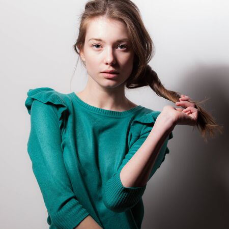 Young beautiful stylish girl posing in studio.の写真素材