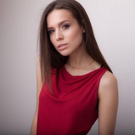 Young beautiful stylish girl posing in studio.の写真素材
