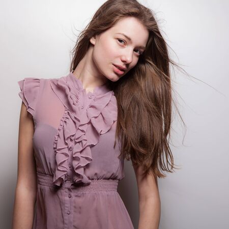 Young beautiful stylish girl posing in studio.の写真素材