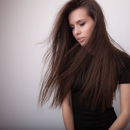 Young beautiful stylish girl posing in studio.の写真素材