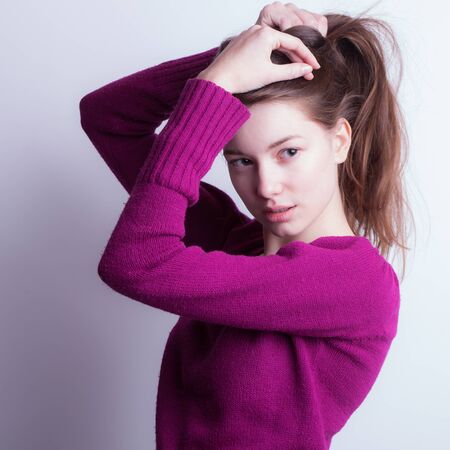 Young beautiful stylish girl posing in studio.の写真素材
