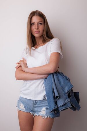 Young beautiful stylish girl posing in studio.の写真素材