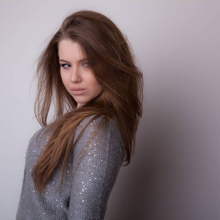Young beautiful stylish girl posing in studio.の写真素材