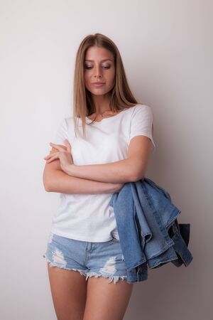 Young beautiful stylish girl posing in studio.の写真素材
