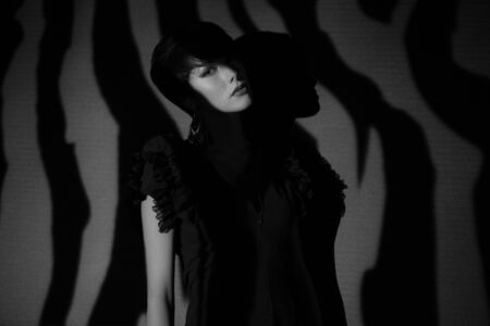 Young beautiful stylish girl posing in studio.の写真素材