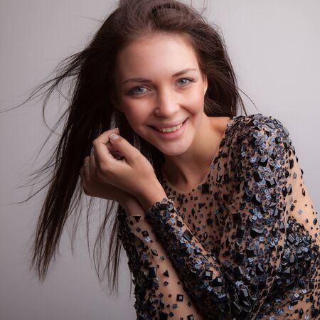 Young beautiful stylish girl posing in studio.の写真素材