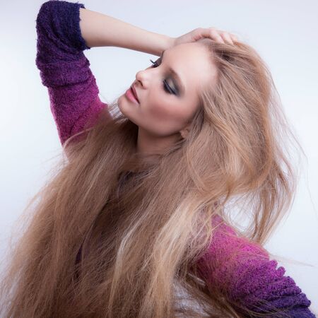 Young beautiful stylish girl posing in studio.の写真素材