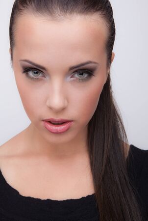 Young beautiful stylish girl posing in studio.の写真素材