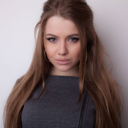 Young beautiful stylish girl posing in studio.の写真素材