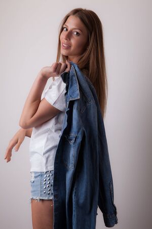 Young beautiful stylish girl posing in studio.の写真素材