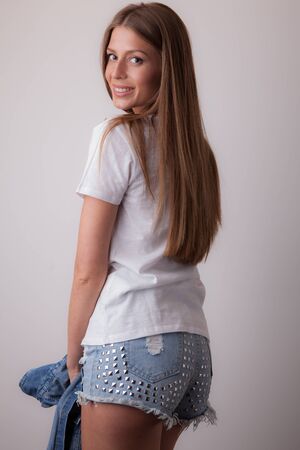 Young beautiful stylish girl posing in studio.の写真素材