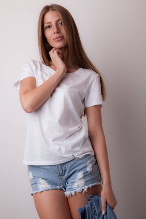 Young beautiful stylish girl posing in studio.の写真素材