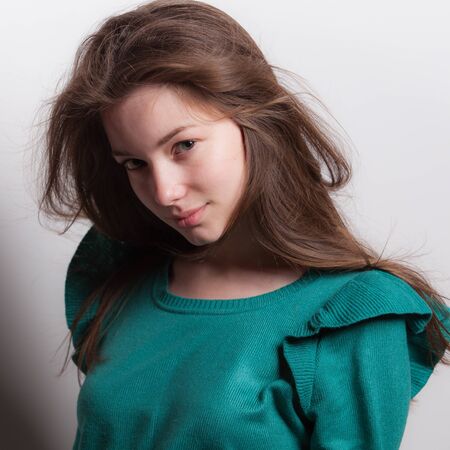 Young beautiful stylish girl posing in studio.の写真素材