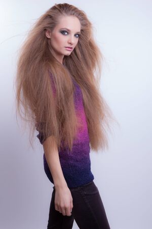 Young beautiful stylish girl posing in studio.の写真素材